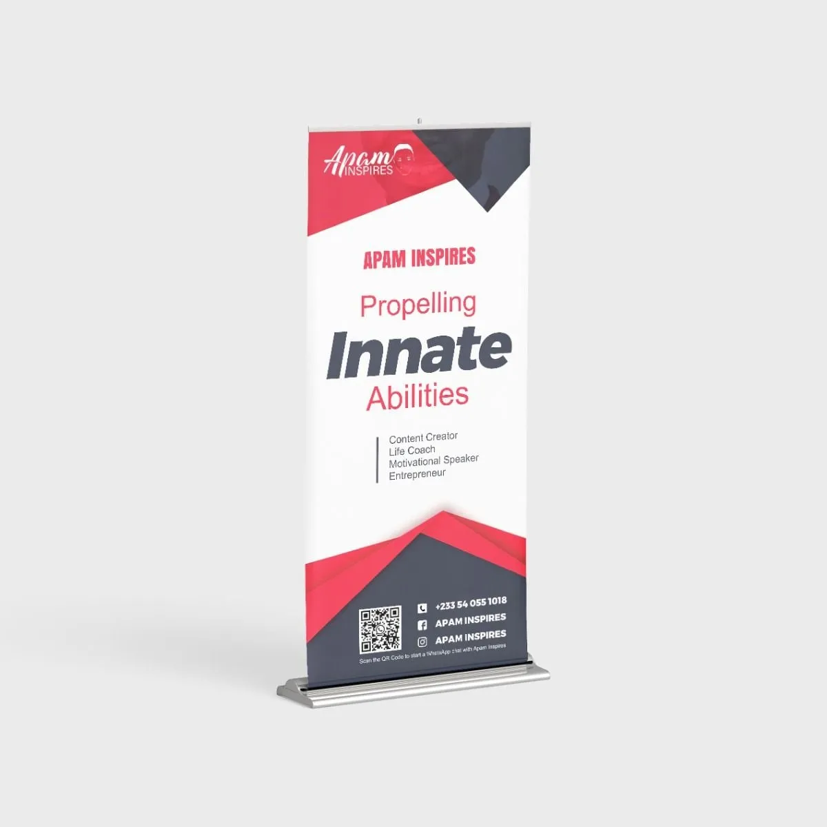 Roll-up banner mockup for Apam Inspires with the tagline Propelling Innate Abilities in red and charcoal.
