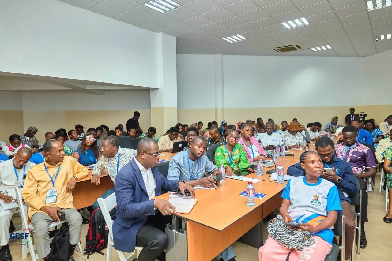A packed hall of delegates with lanyards seated at conference tables during the Ghana Civil Society Forum 2026